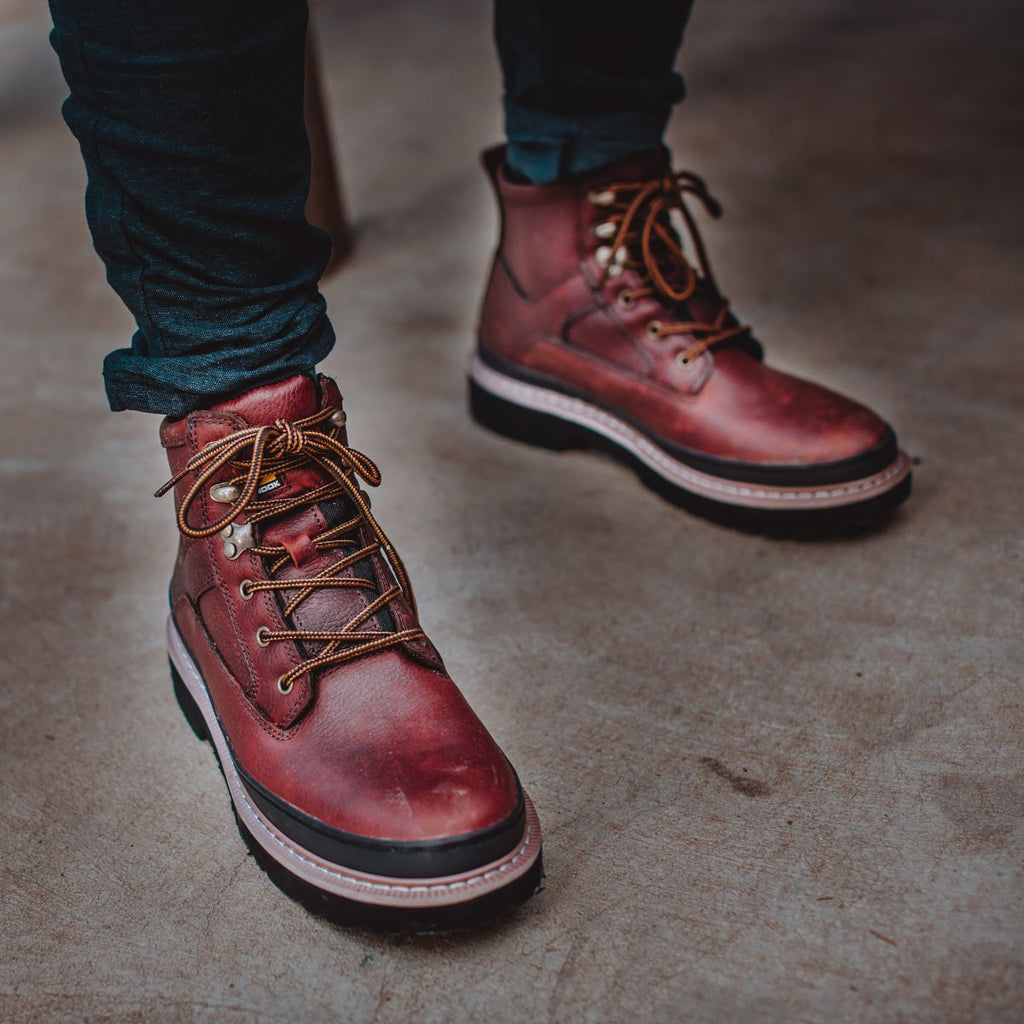 Close-up of Workhorse II 6" Soft Toe Men’s Work Boots in Brown, worn indoors. The boots feature a classic lace-up design with durable leather and a sturdy sole, perfect for all-day comfort and light-duty work.